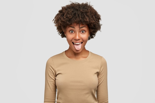 shot-funny-black-woman-shows-tongue-has-playful-expression-afro-hairstyle_273609-17839.jpg